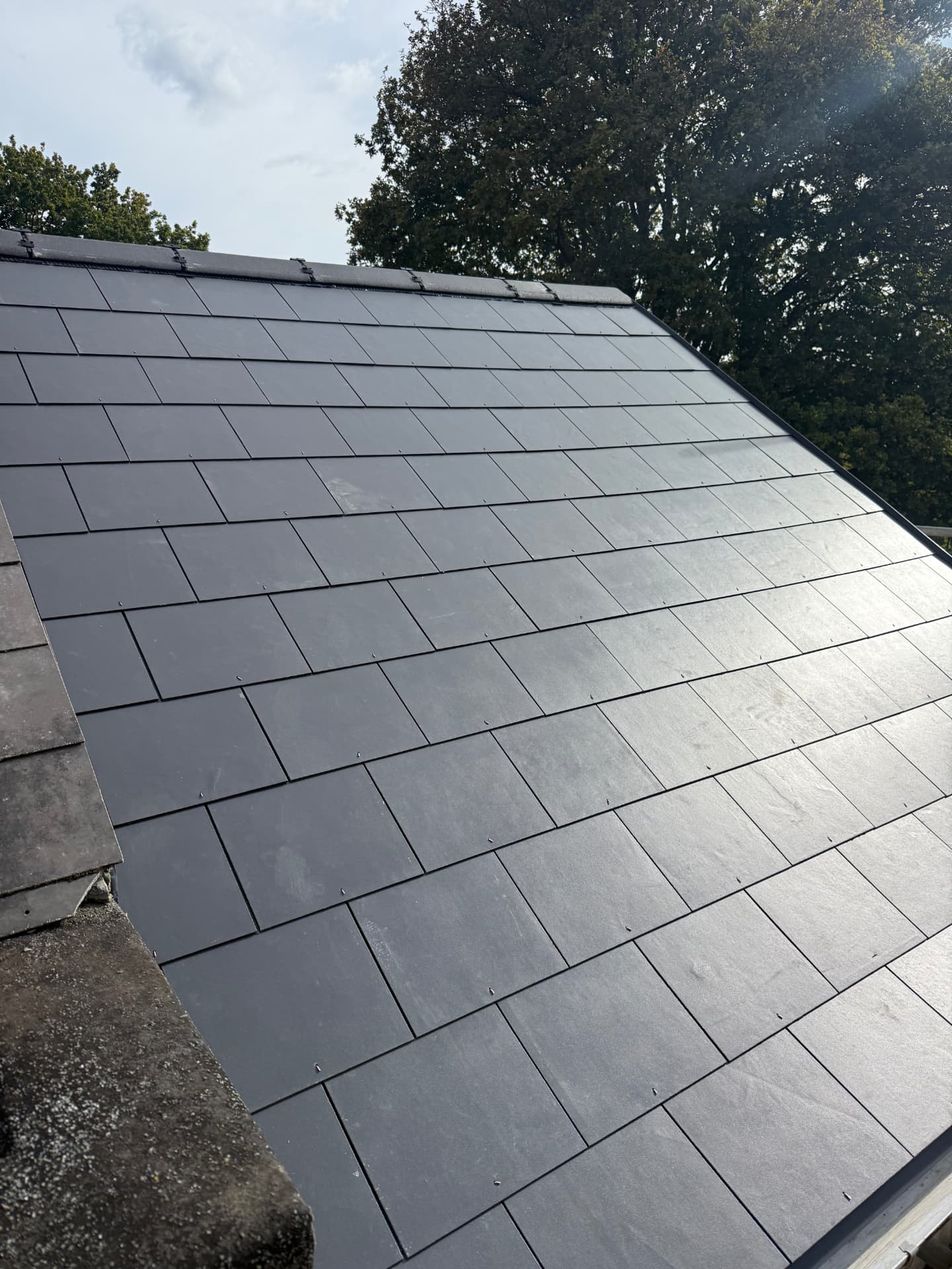 Slate pitched roof re-covered in dark natural slate