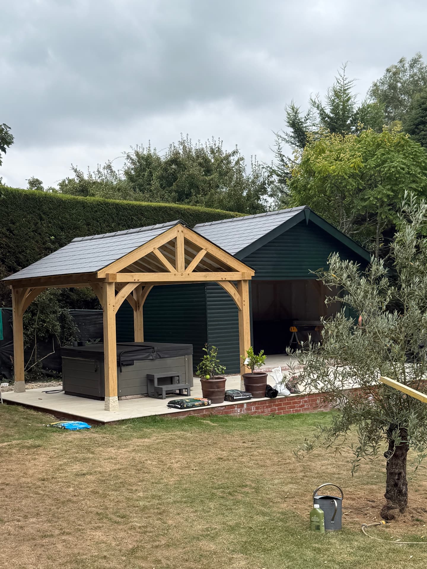 Slate pitched roof on a garden outbuilding with oak porch