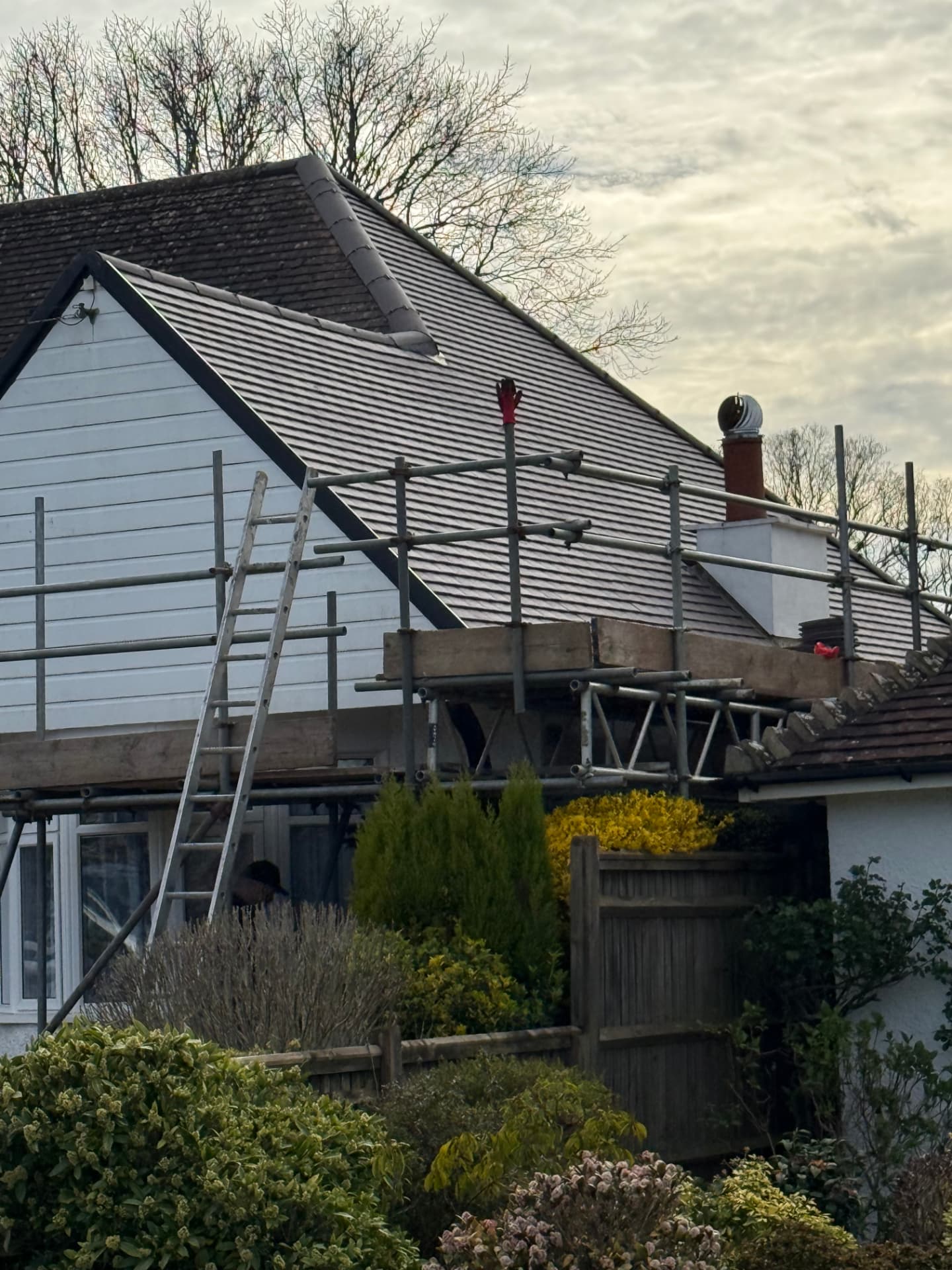 Pitched roof re-roof in progress with scaffolding in place